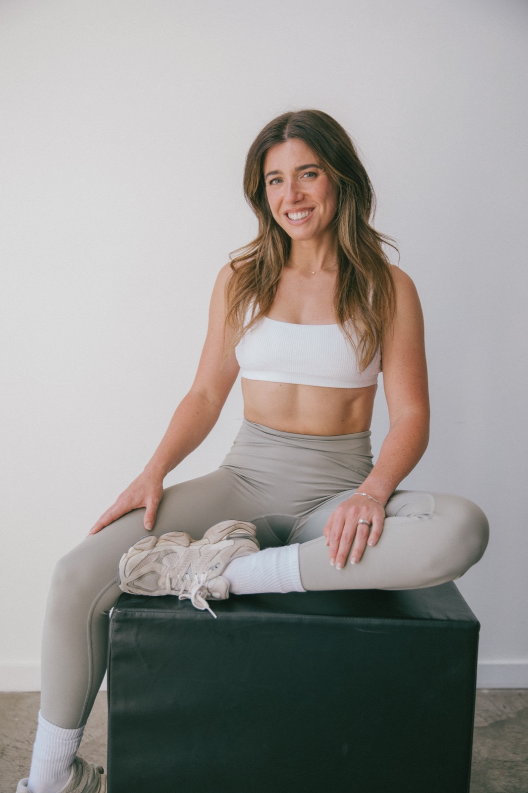 Alex sitting on a plyo box, smiling at the camera