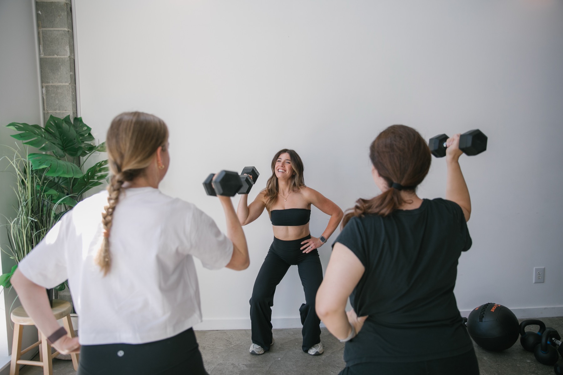 Alex training with a dumbbell in the studio