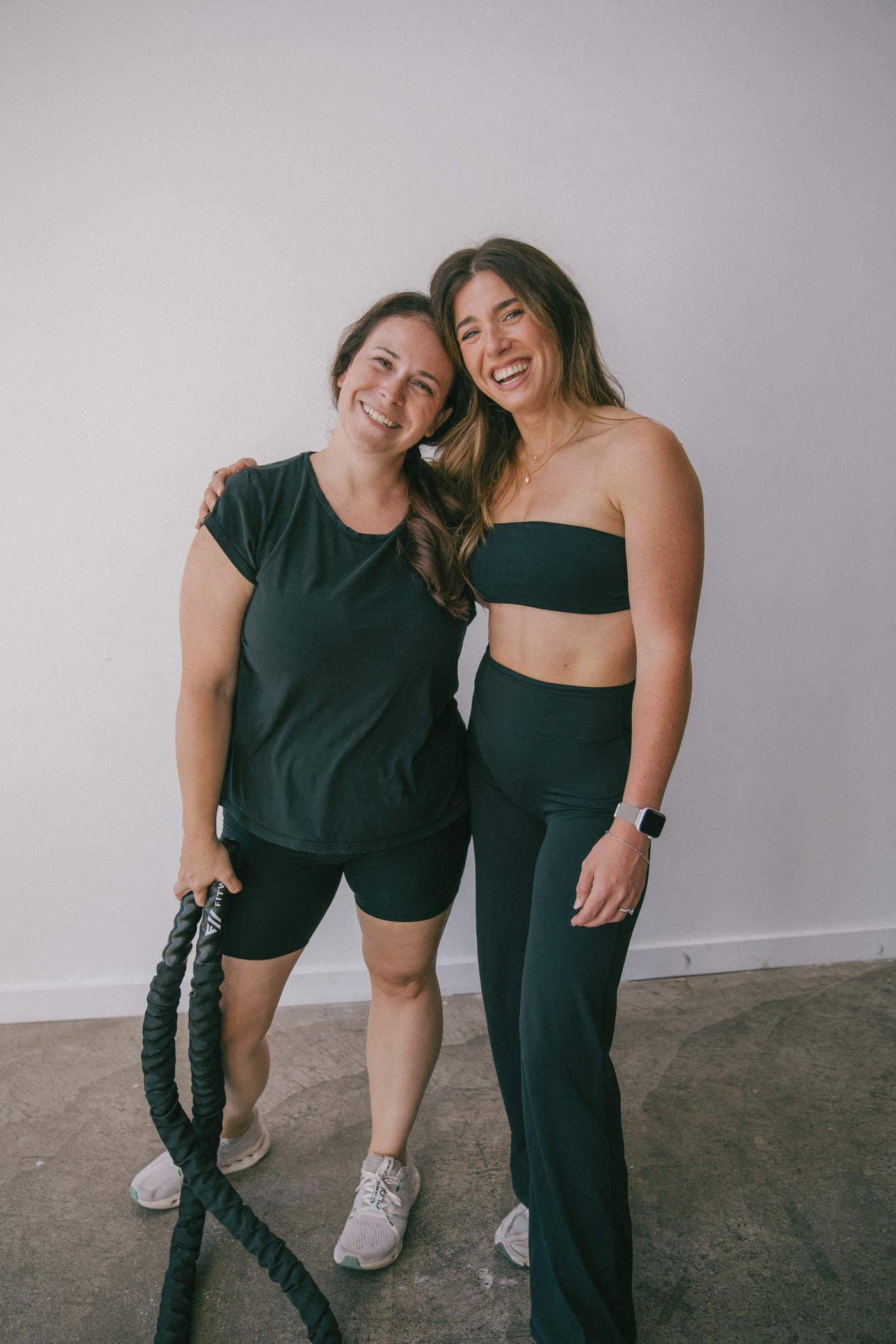 Alex standing with a client in the studio, both smiling